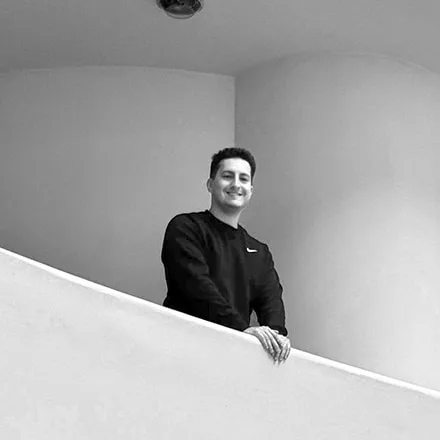 Juan Ignacio Colacilli, founder of CUBIQA, leaning on a curved white balcony